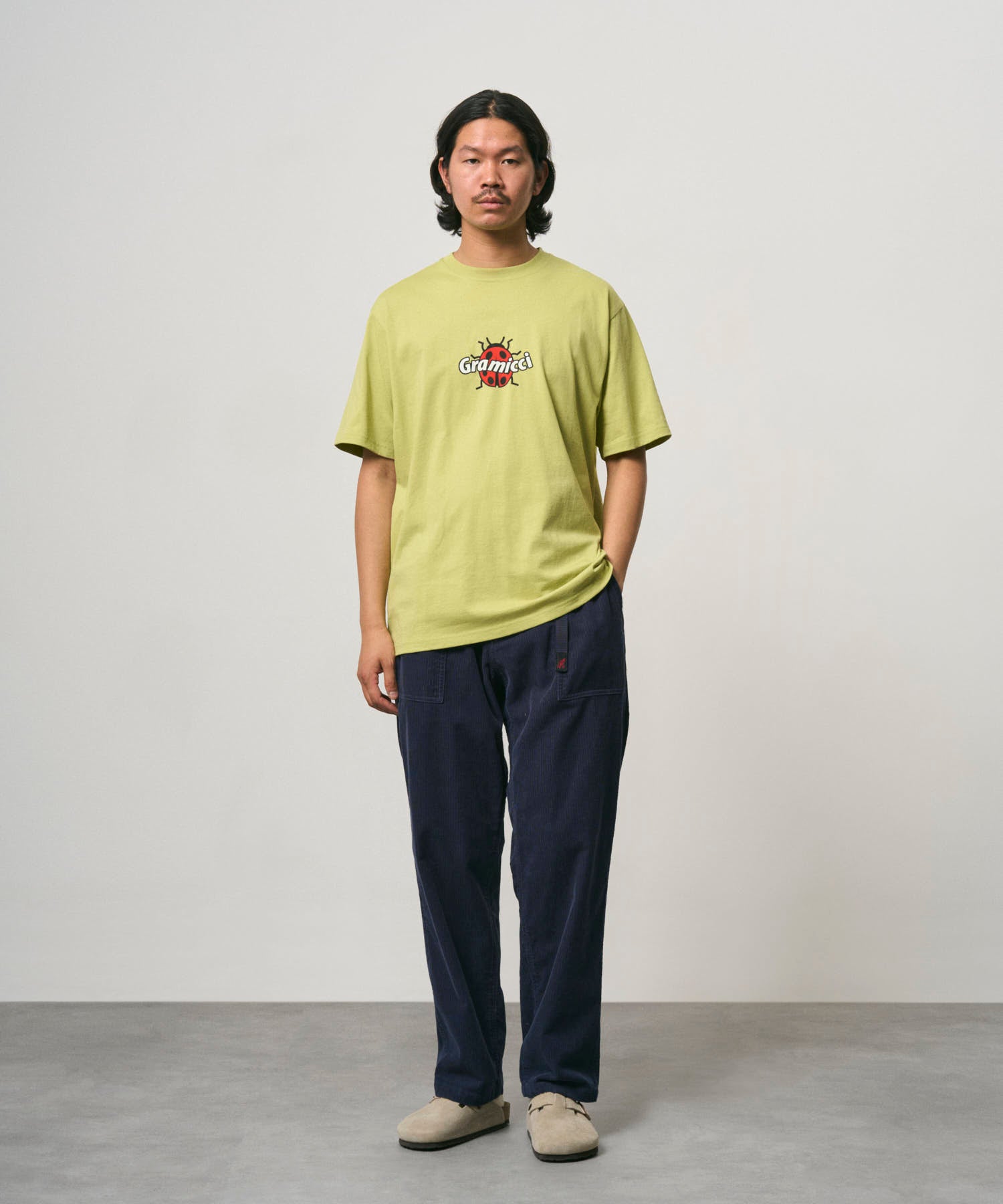 Model wearing Gramicci Ladybug Tee Sweet Pea relaxed fit cotton graphic T-shirt