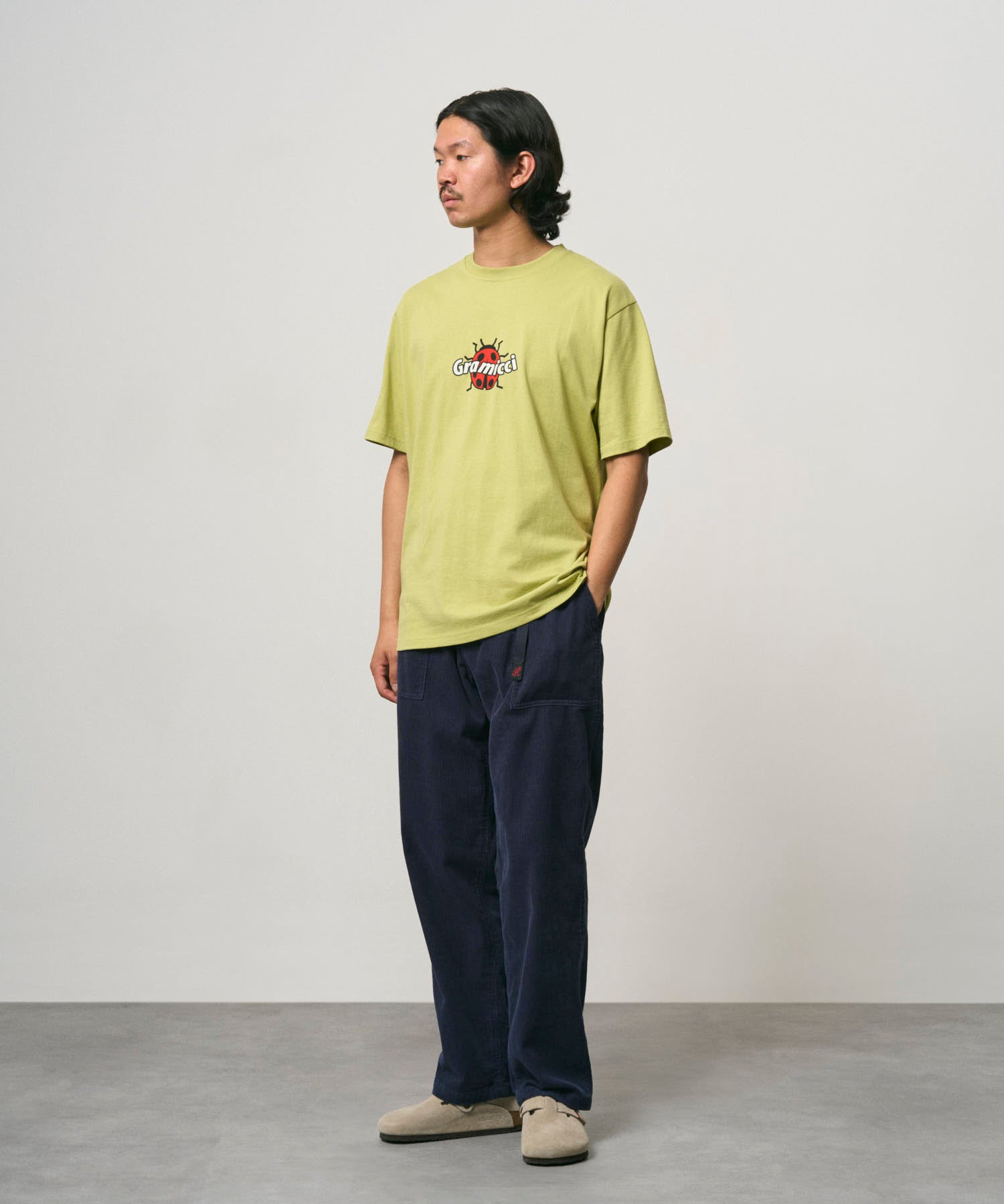 Male model wearing Gramicci Ladybug Tee Sweet Pea relaxed fit graphic T-shirt
