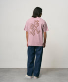 Back view of model wearing Gramicci Livin Tee Lilac Pigment relaxed fit T-shirt