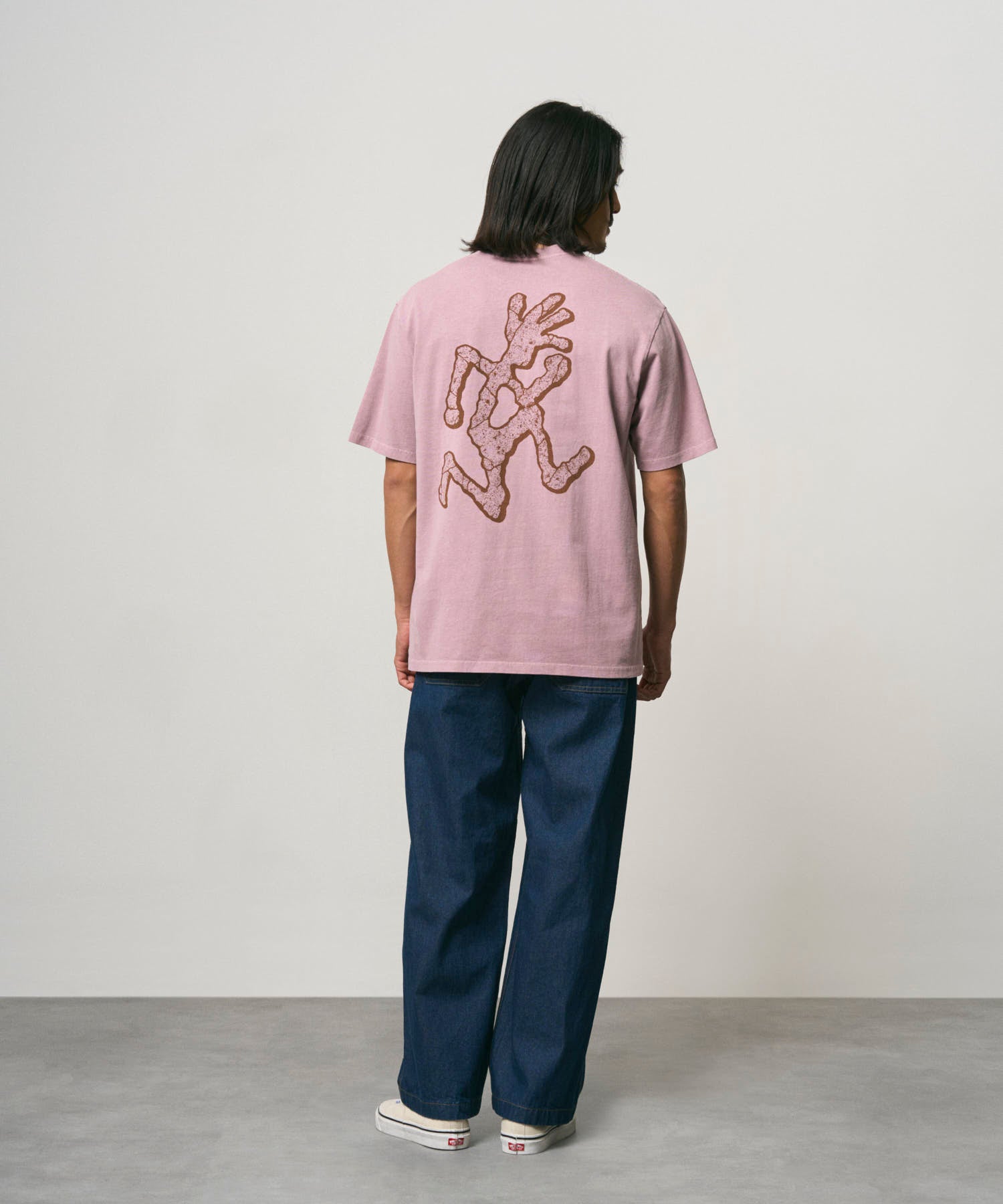 Back view of model wearing Gramicci Livin Tee Lilac Pigment relaxed fit T-shirt