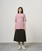 Side view of woman wearing Gramicci Livin Tee Lilac Pigment cotton T-shirt