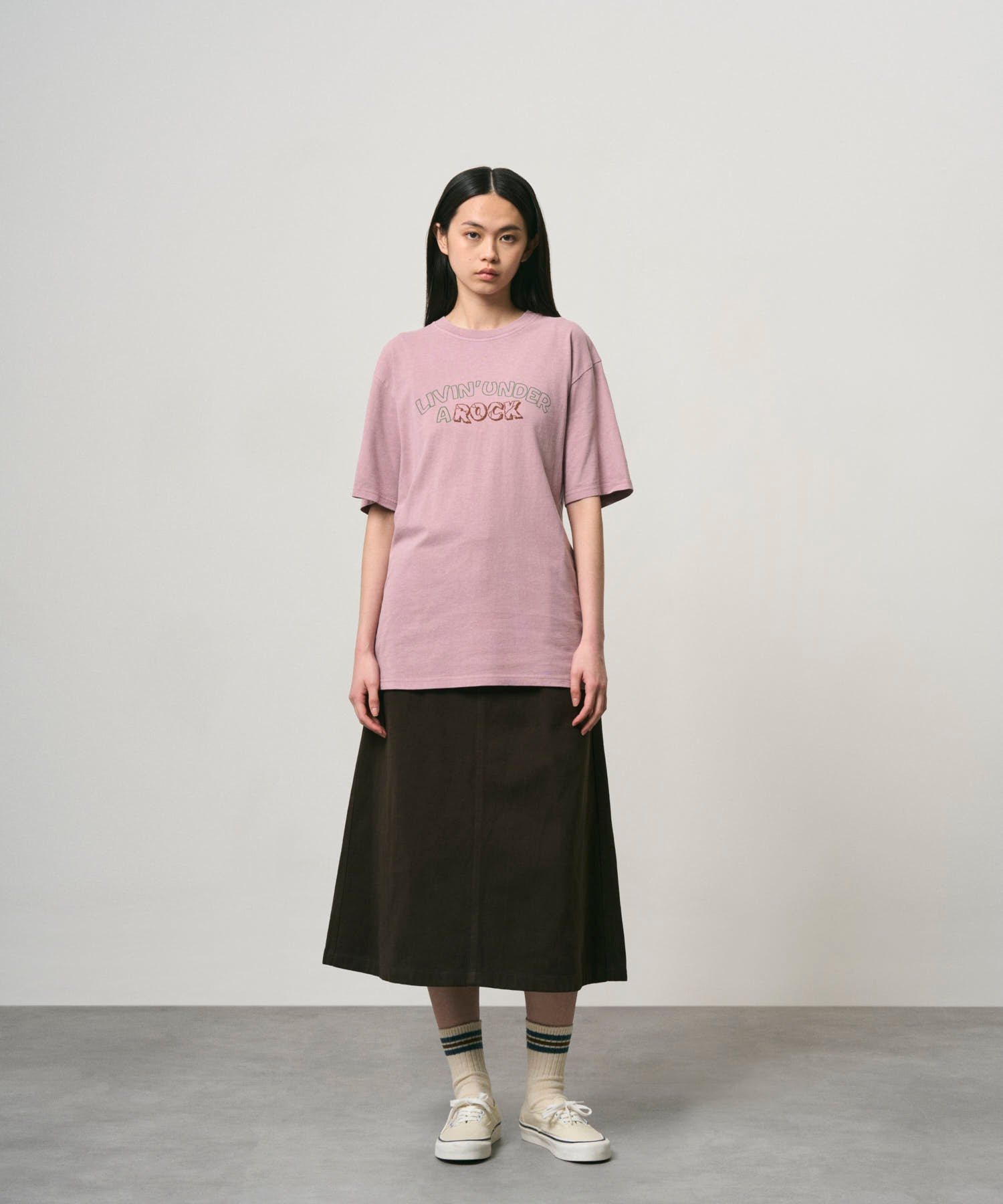 Side view of woman wearing Gramicci Livin Tee Lilac Pigment cotton T-shirt
