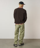 Model wearing Gramicci Pant Cactus Pigment relaxed fit cotton twill pants with cinch belt by LE.SHOP
