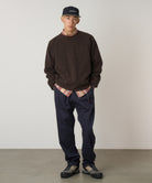 Model wearing Gramicci Pant Double Navy relaxed fit cotton twill pants with cinch belt by LE.SHOP