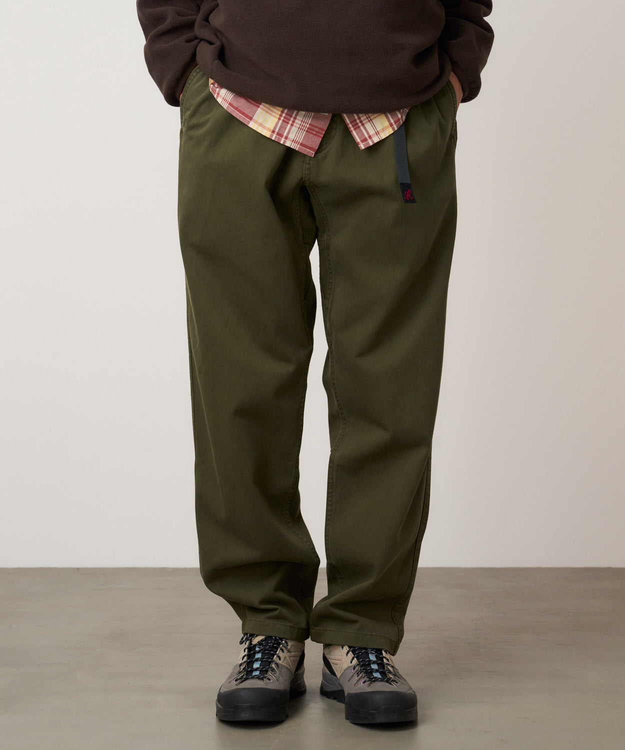Model wearing Gramicci Pant Pine relaxed fit cotton twill utility pants with cinch belt by LE.SHOP