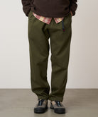 Model wearing Gramicci Pant Pine relaxed fit cotton twill utility pants with cinch belt by LE.SHOP