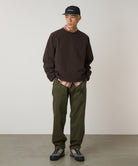 Model wearing Gramicci Pant Pine relaxed fit cotton twill utility pants with cinch belt by LE.SHOP