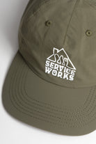 Olive green Home Comforts cotton cap side view for everyday wear