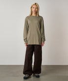 Front view of model wearing khaki long sleeve t-shirt with regular fit and chest logo, styled for everyday comfort