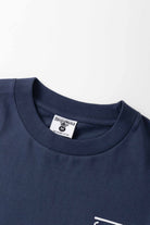 Detail view of navy Milos Tee highlighting organic cotton fabric, midweight texture and high-quality everyday streetwear construction