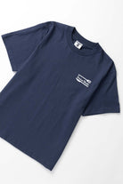 Model wearing navy Milos Tee shown from back featuring organic cotton fabric, clean silhouette and relaxed streetwear fit