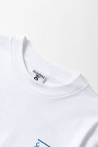 Detail view of white Milos Tee highlighting organic cotton fabric, midweight texture and high-quality everyday streetwear construction