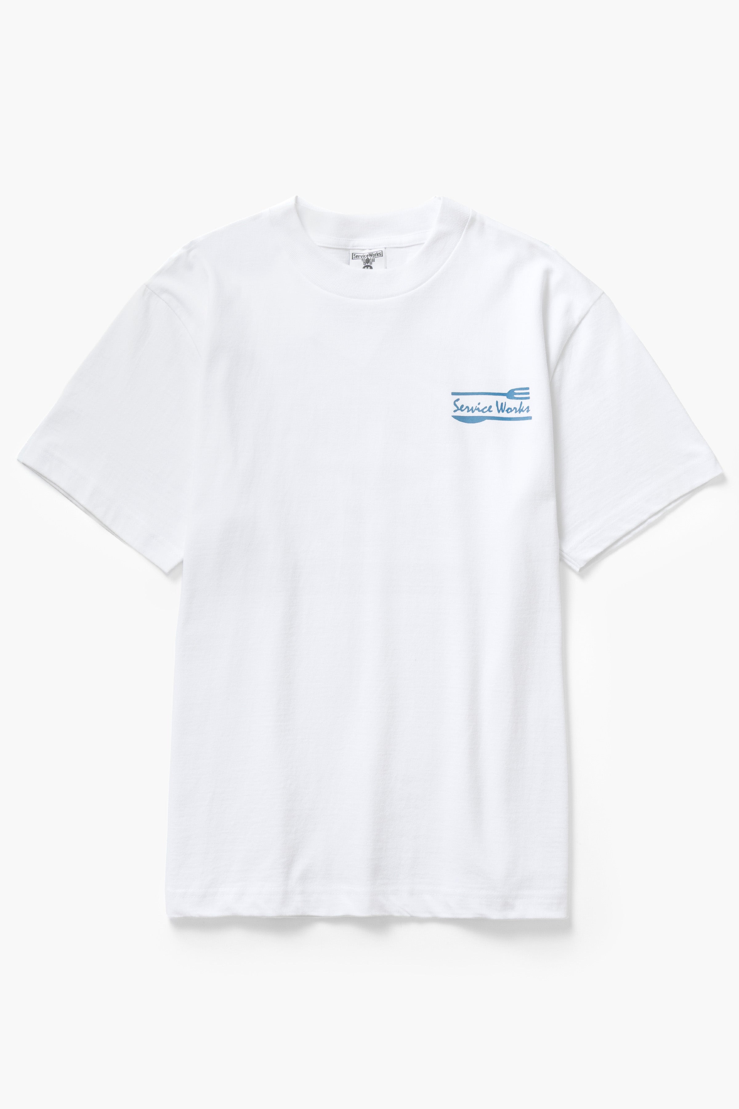 Front view of model wearing white Milos Tee featuring organic cotton fabric, standard fit and clean everyday streetwear style