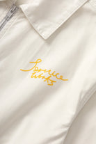 Front detail of off white twill work jacket for men showing structured design and durable fabric