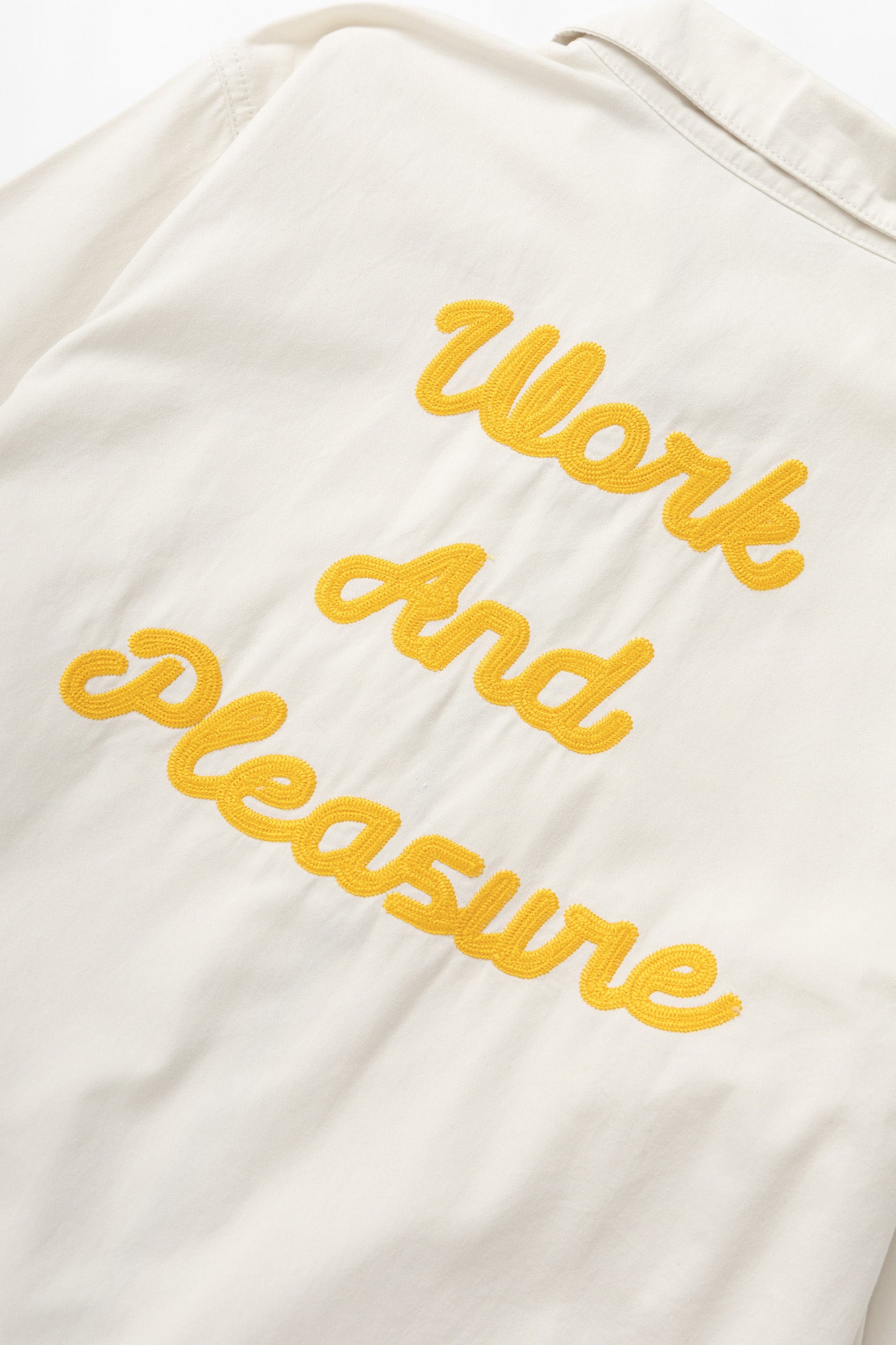 Detail of off white twill work jacket pocket design for men, durable utility workwear styling