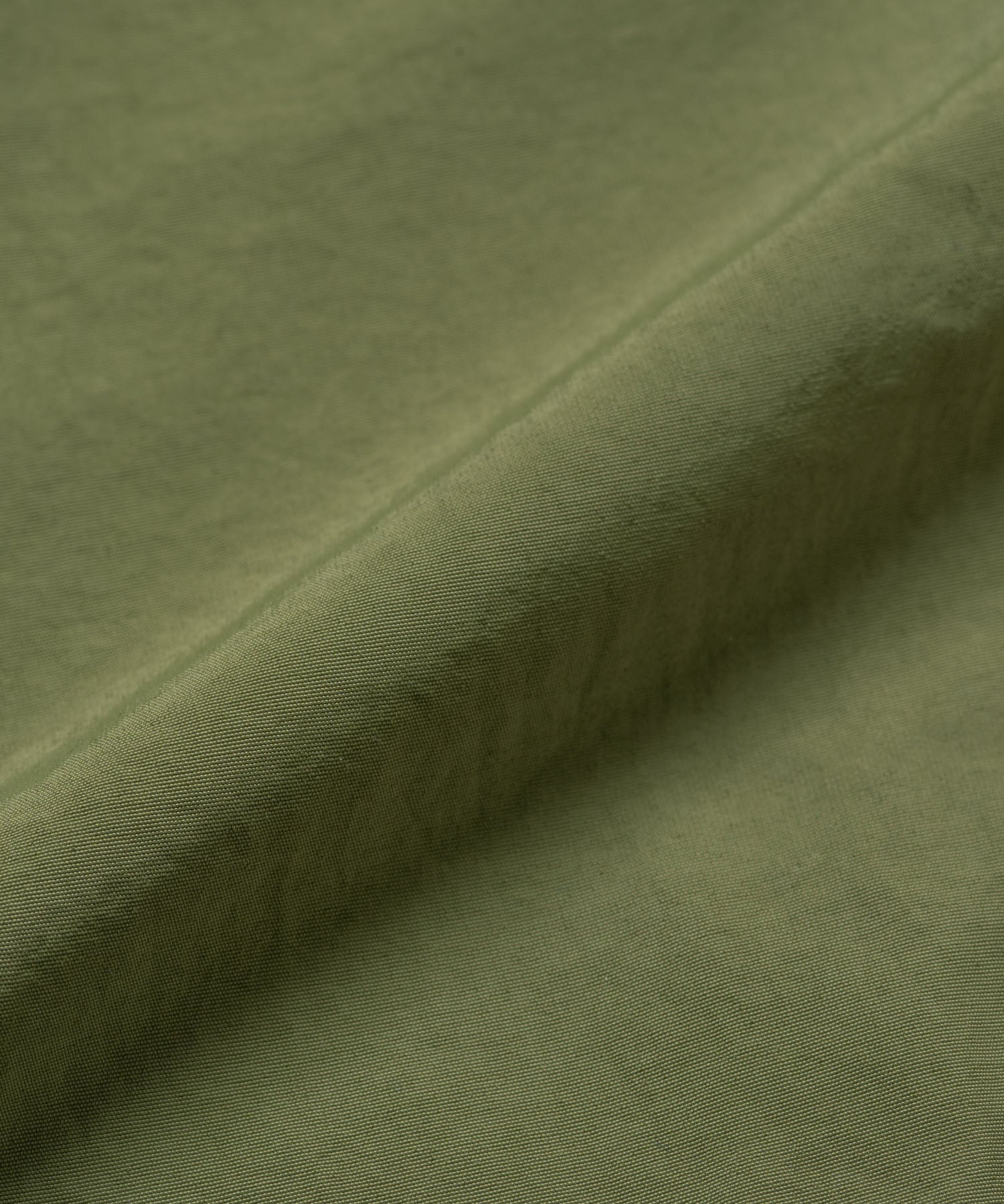 Olive nylon paneled trek pants with wide-leg relaxed fit and durable lightweight fabric, front product view for everyday and streetwear style
