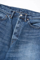 Close-up of Ordinary Fits relaxed fit jeans showing stitching and denim texture
