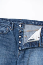 Close-up of Ordinary Fits relaxed fit jeans waistband and button closure detail