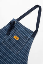 Indigo pinstripe denim apron back view adjustable straps premium workwear cooking barista workshop