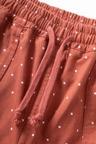 Close-up of clay Polka Dot Chef Pants on model showing organic cotton fabric, relaxed straight fit and everyday streetwear-inspired workwear design