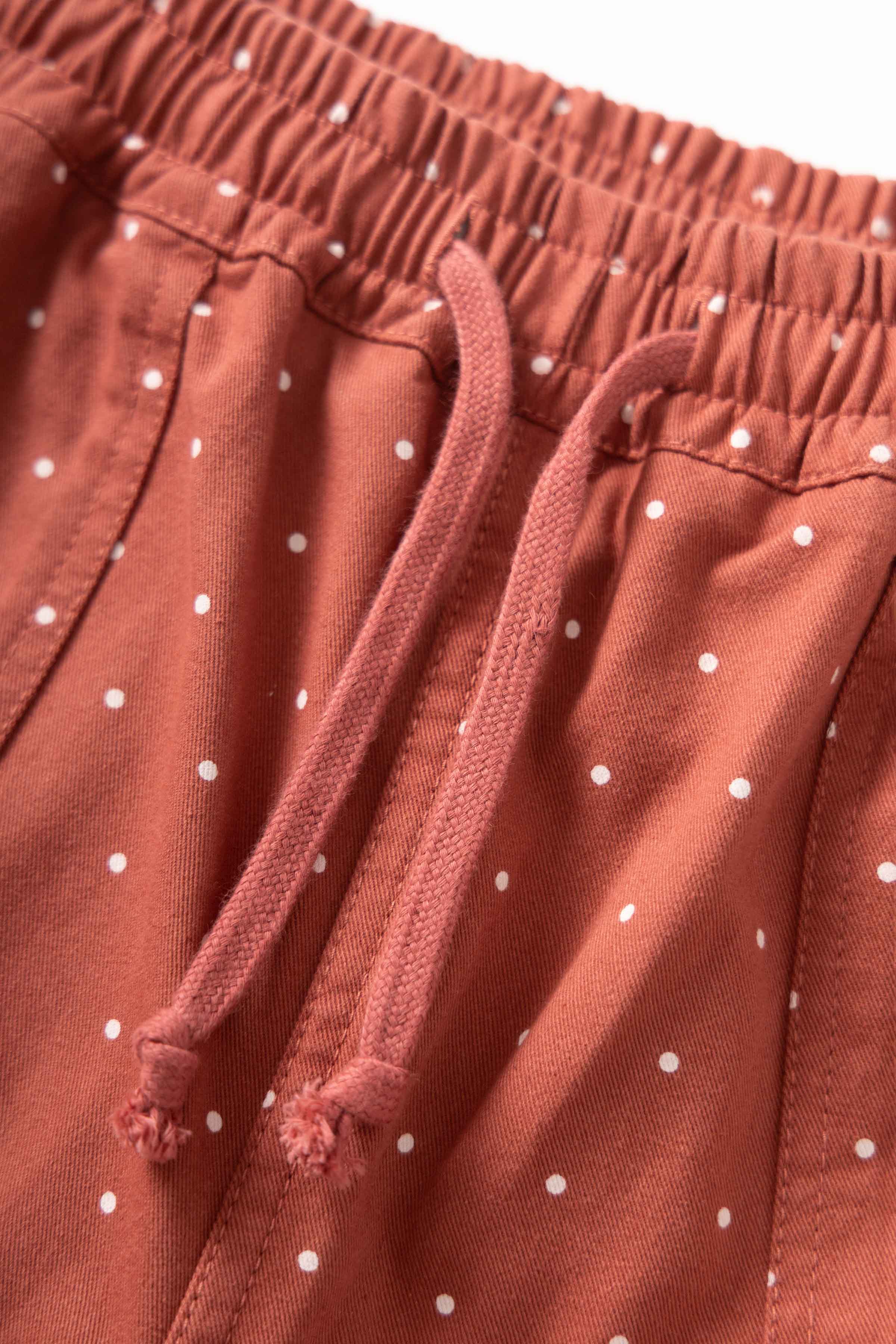 Close-up of clay Polka Dot Chef Pants on model showing organic cotton fabric, relaxed straight fit and everyday streetwear-inspired workwear design