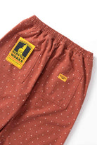 Model wearing clay Polka Dot Chef Pants shown from back, featuring organic cotton fabric, relaxed silhouette and durable workwear construction