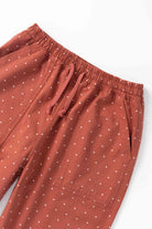 Front view of model wearing clay Polka Dot Chef Pants featuring organic cotton fabric, relaxed fit and functional workwear styling