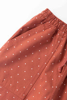 Model wearing clay Polka Dot Chef Pants shown from side angle, featuring organic cotton fabric, relaxed silhouette and functional workwear design