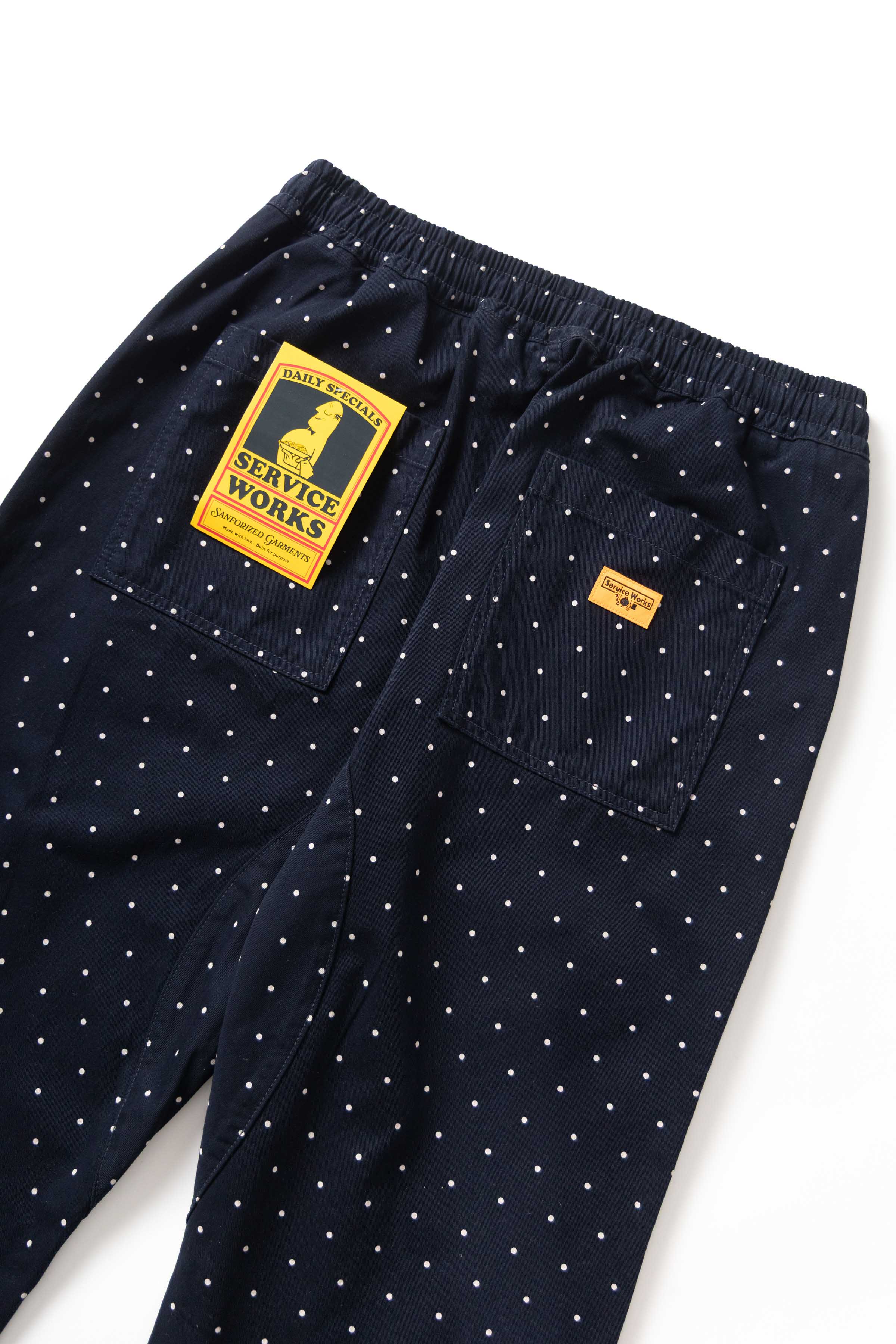 Detail view of navy Polka Dot Chef Pants highlighting organic cotton fabric, reinforced stitching and functional workwear pocket design