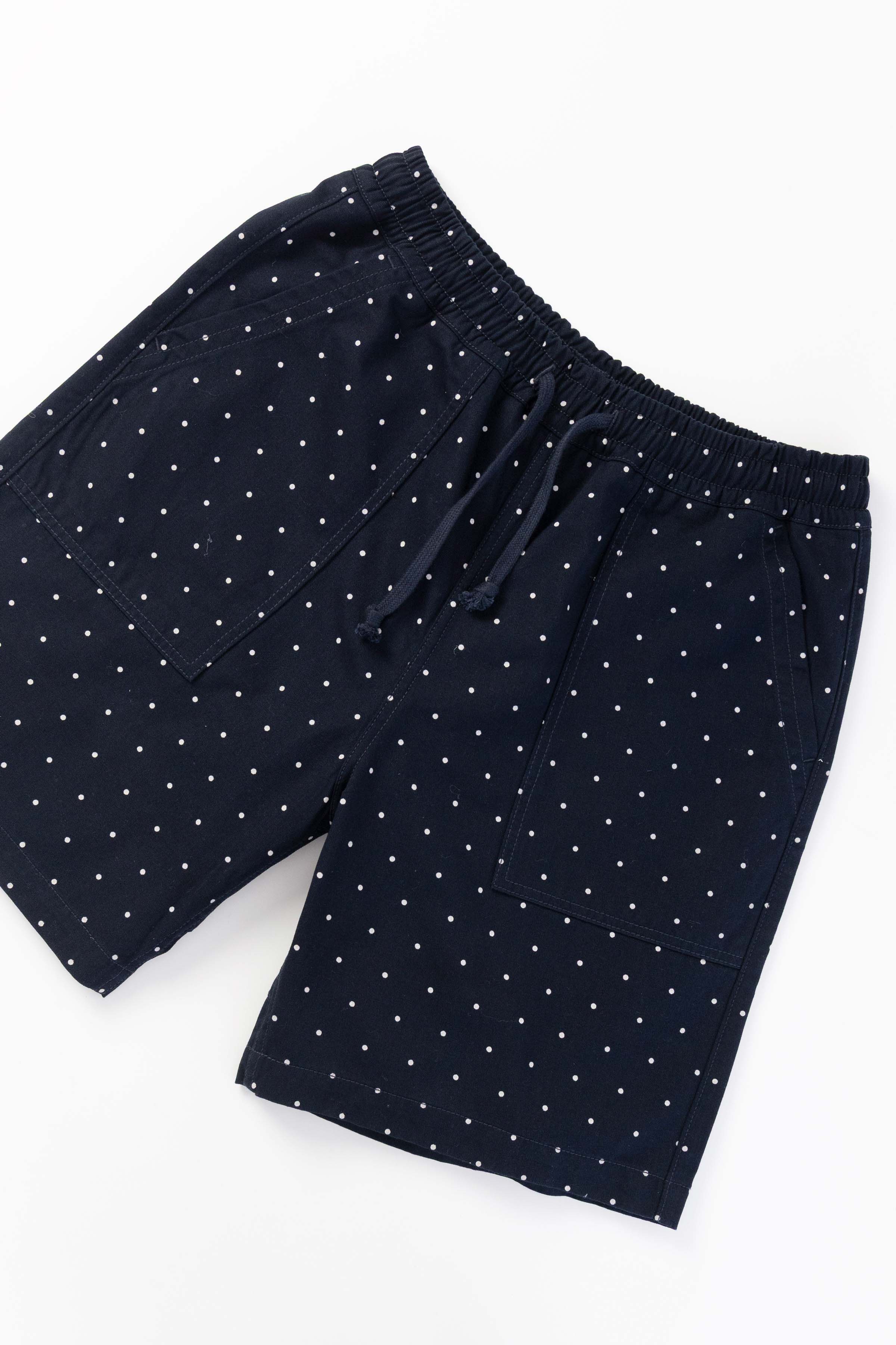 Front view of model wearing navy Polka Dot Chef Shorts featuring organic cotton fabric, relaxed silhouette and functional workwear styling