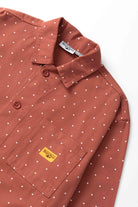 Model wearing clay Polka Dot Chore Shirt shown from side angle, featuring organic cotton fabric, relaxed workwear silhouette and functional pocket details
