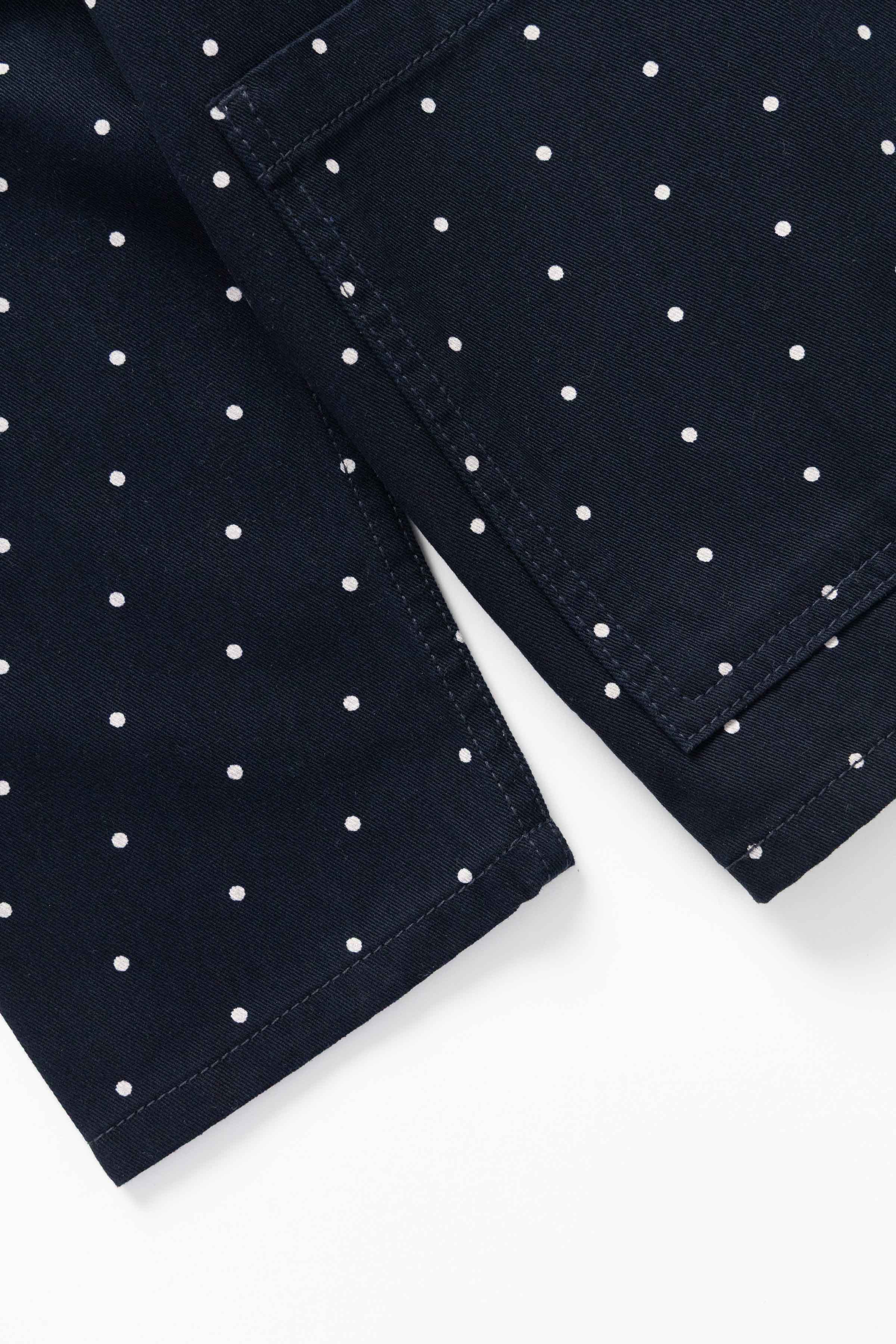 Model wearing Polka Dot Chore Shirt in navy styled for everyday workwear, made from GOTS organic cotton drill with relaxed fit and utility design