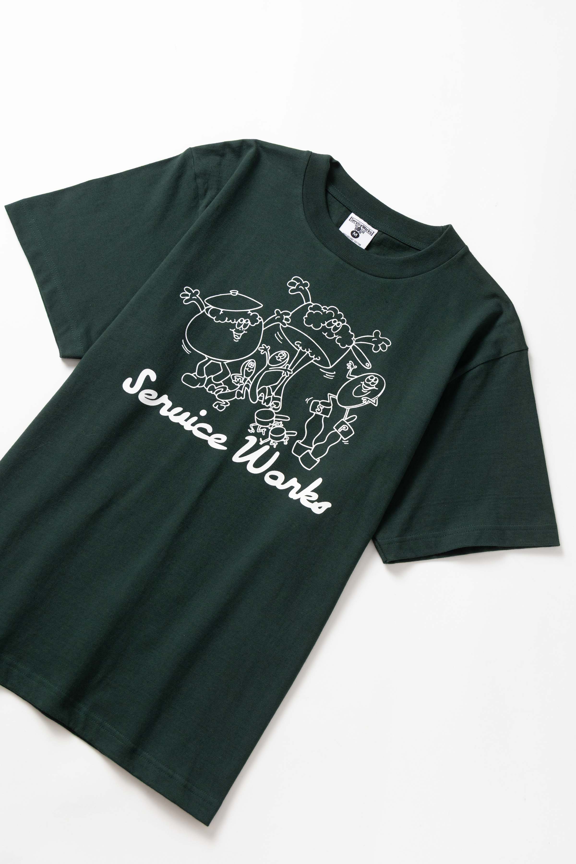 Front view of model wearing forest Pots & Pans Tee featuring organic cotton fabric, clean fit and casual streetwear styling