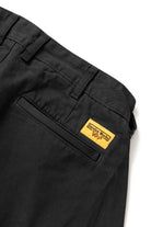Close-up of the Service Works Drill Part Timer Pant in Black showing belt loops and waistband construction for adjustable fit.