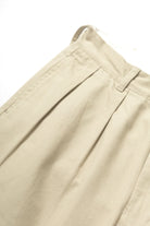 Close-up detail of Service Works Drill Part Timer pants in khaki showing fabric and pleated construction