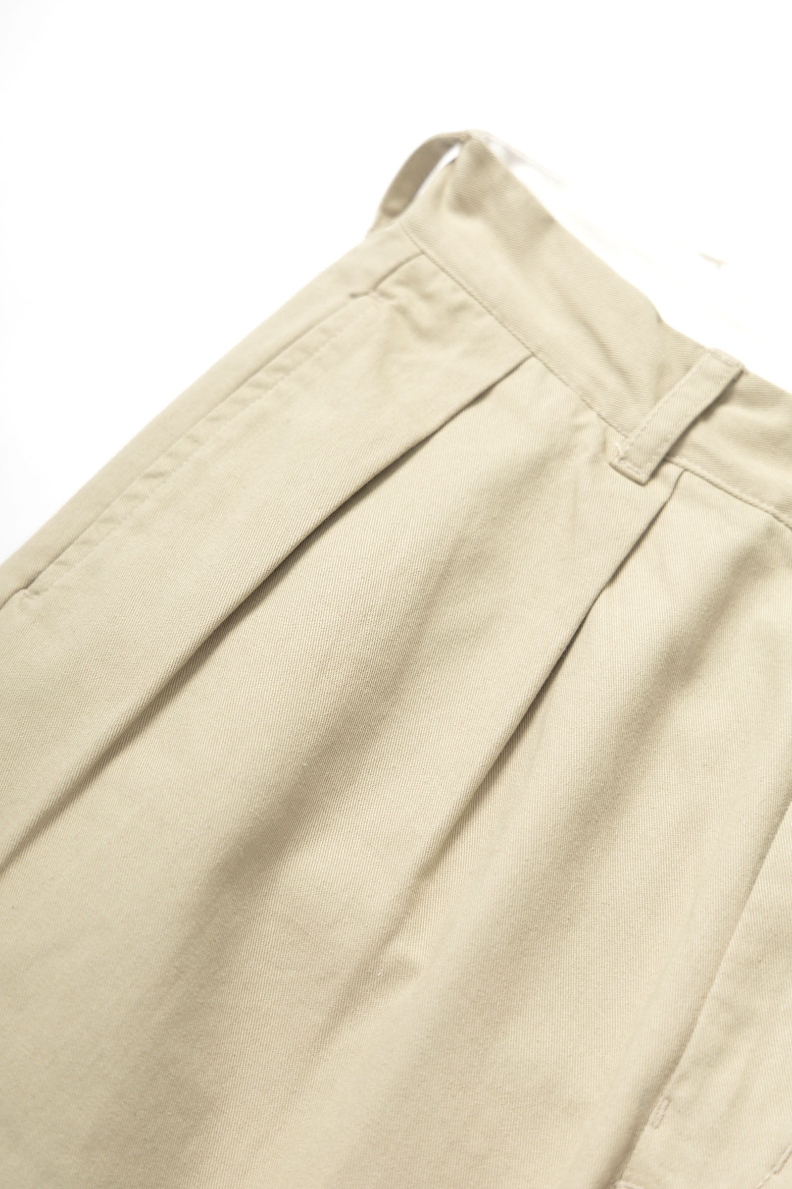Close-up detail of Service Works Drill Part Timer pants in khaki showing fabric and pleated construction