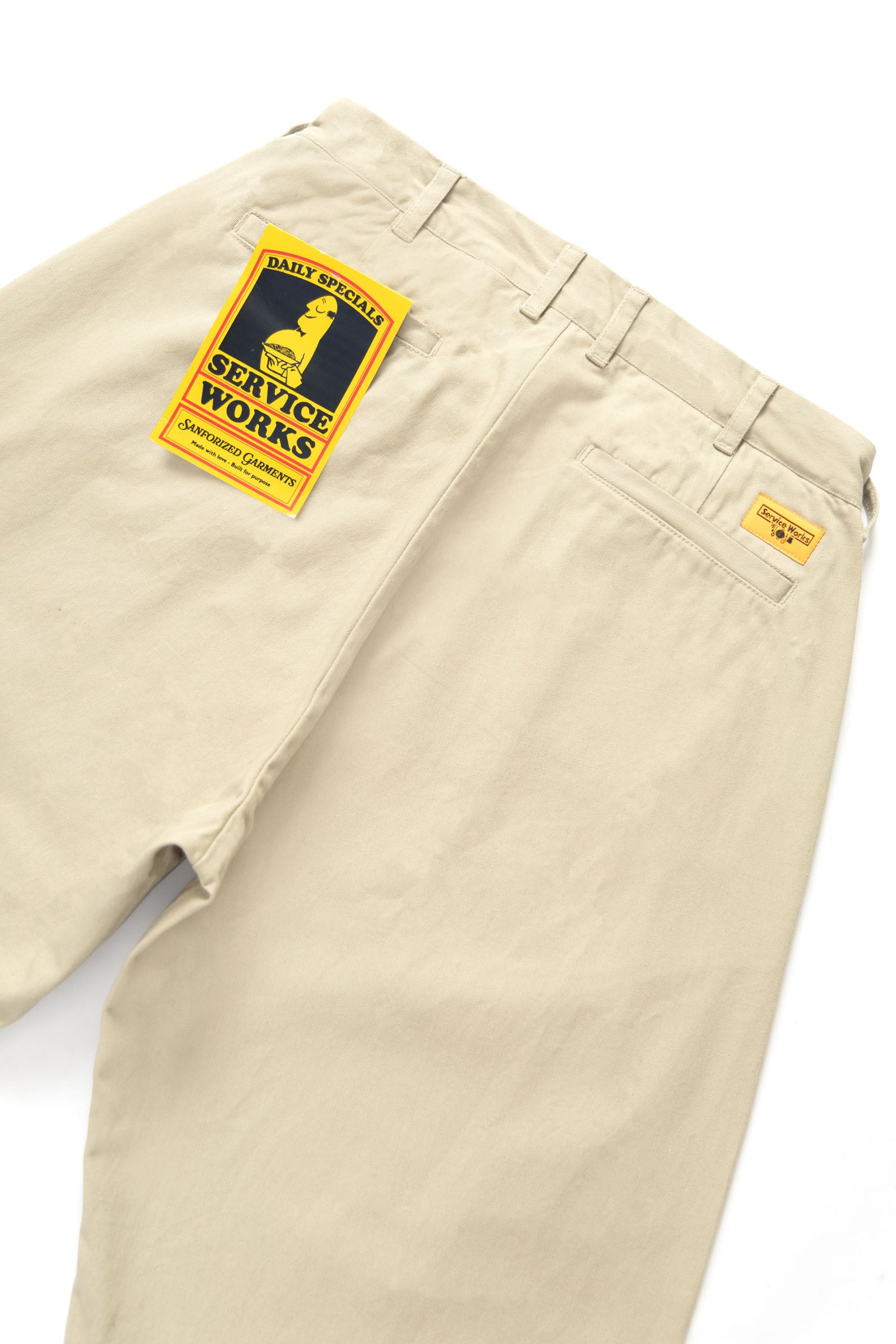 Service Works khaki pleated pants label and branding detail shot