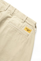 Service Works Drill Part Timer pants in khaki showing branded yellow label detail on workwear trousers