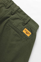 Service Works Drill Part Timer shorts in olive showing branded label detail on workwear shorts