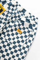 Close-up of the Service Works Printed Chef Short in Teal Checker highlighting fatigue pockets and durable utility construction.