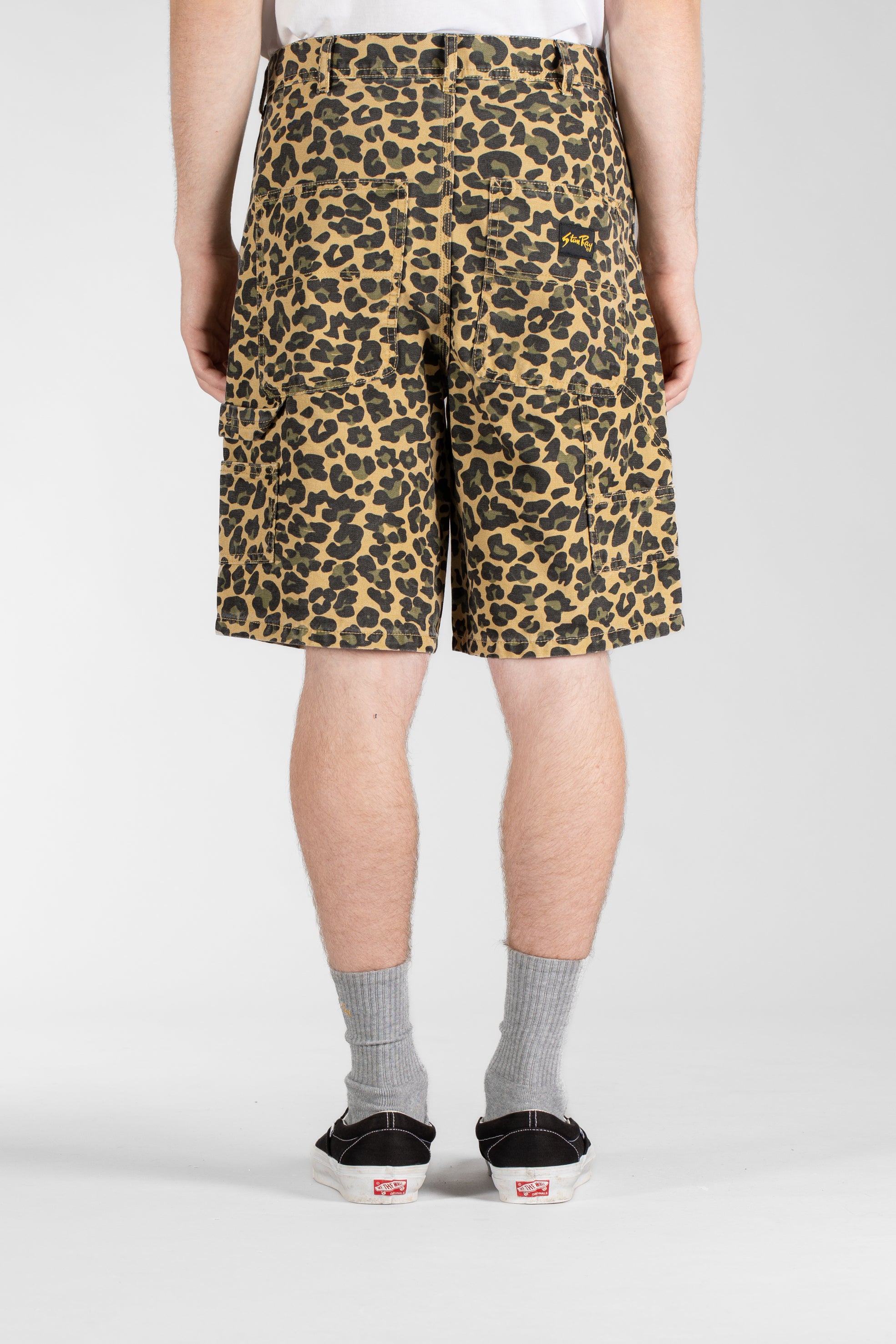 Back view of model wearing Stan Ray Big Job Short Leopard Camo oversized painter shorts with durable cotton twill, utility pockets and relaxed fit.
