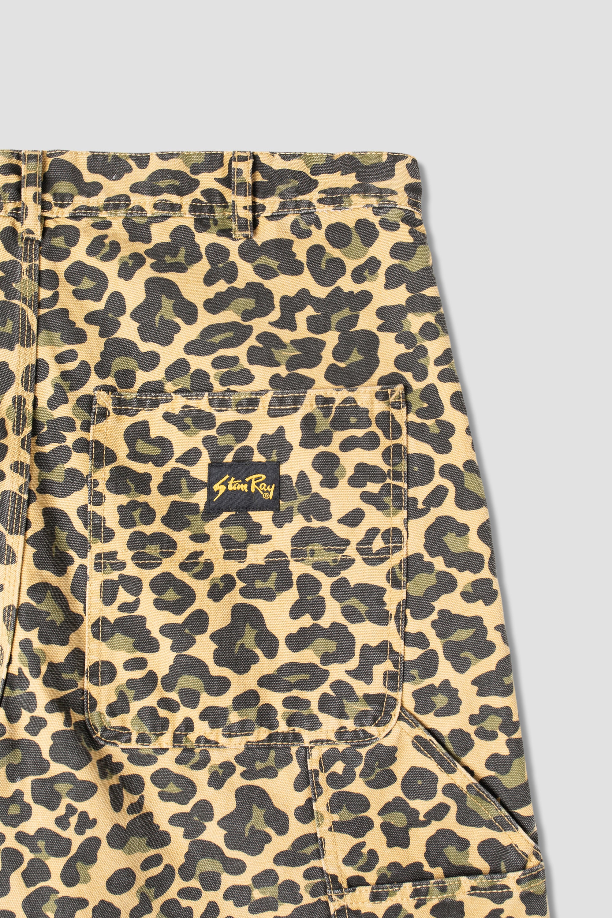 Close-up detail of Stan Ray Big Job Short Leopard Camo showing durable cotton twill fabric, utility pockets and bold leopard camo print.
