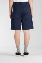 Side view of model wearing Stan Ray Big Job Short Navy Duck oversized painter shorts with durable cotton twill and relaxed fit.