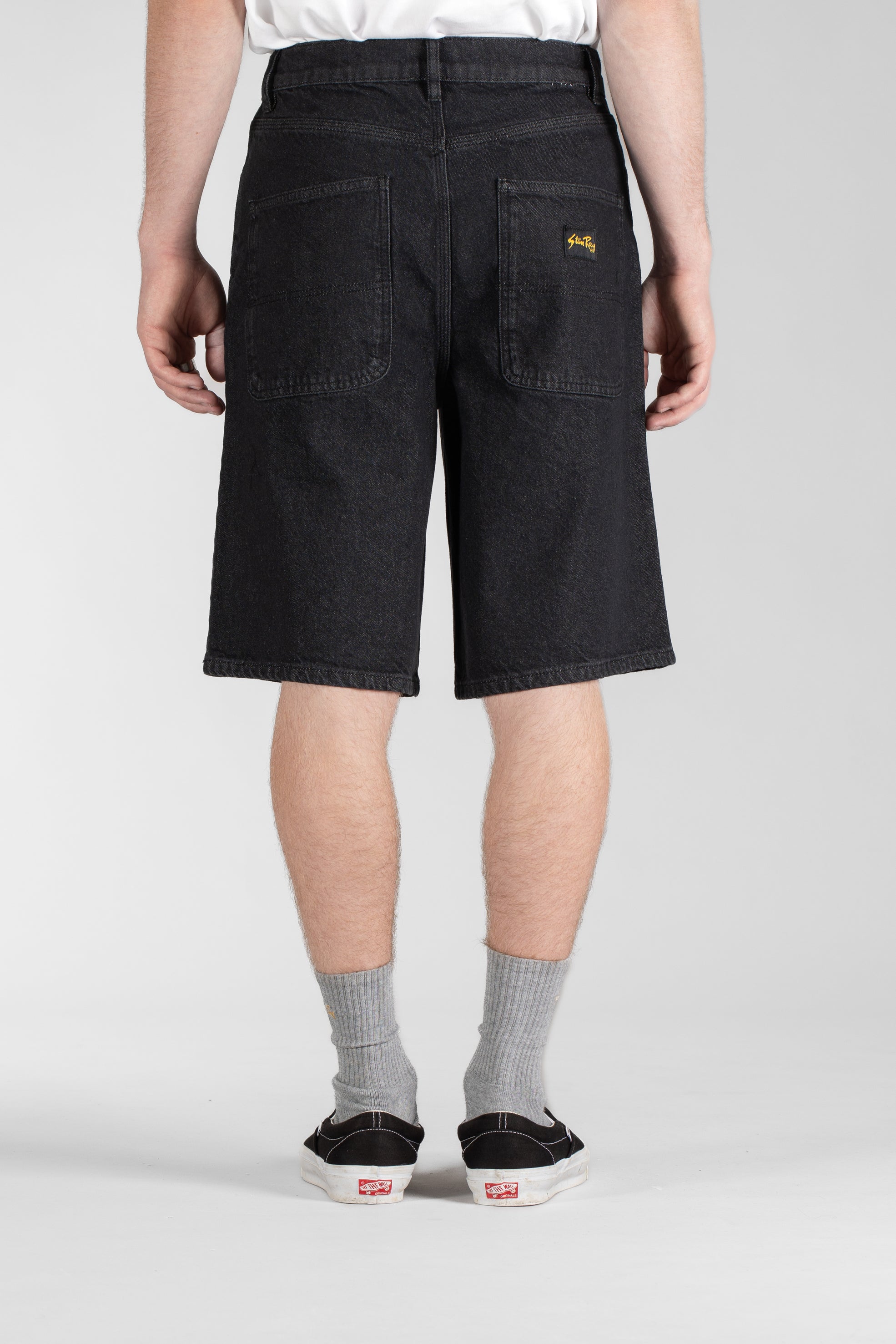 Side view of model wearing Stan Ray Wide 5 Short Charcoal Denim made from heavyweight cotton denim with relaxed wide-leg fit.