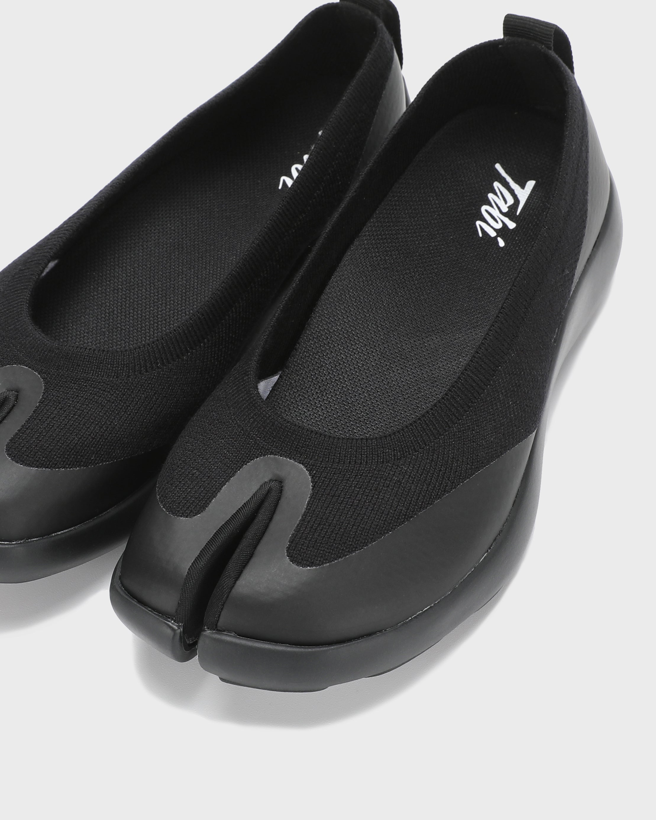 Close-up front view of black Tabi Ballerina shoes highlighting the signature split toe design