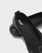 Close-up of the logo detail on black Tabi Ballerina shoes