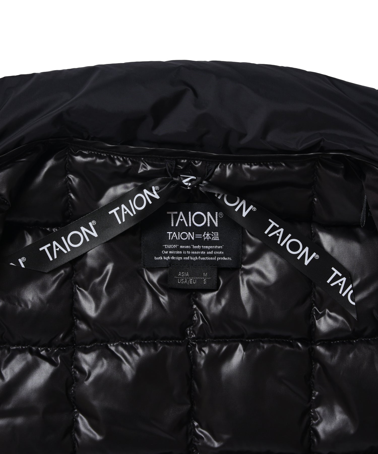 Close-up brand tag detail of Taion Hi Neck W-Zip Down Jacket in Off White with premium branding finish