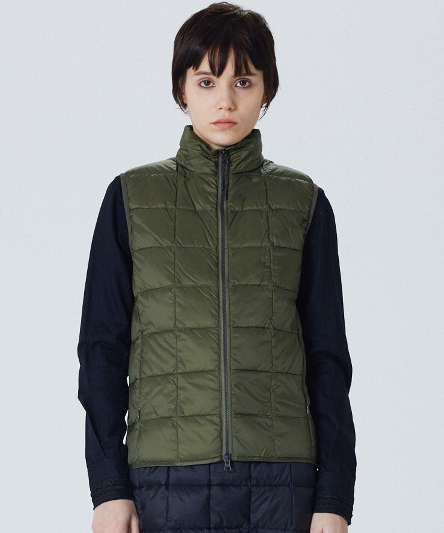 Model wearing Taion Hi Neck W-Zip Down Vest in D.Olive
