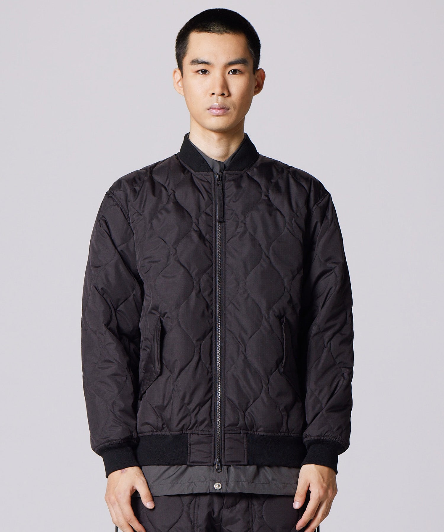 Model wearing Taion Military MA-1 Type Down Jacket in Black with insulated bomber-style fit and everyday comfort