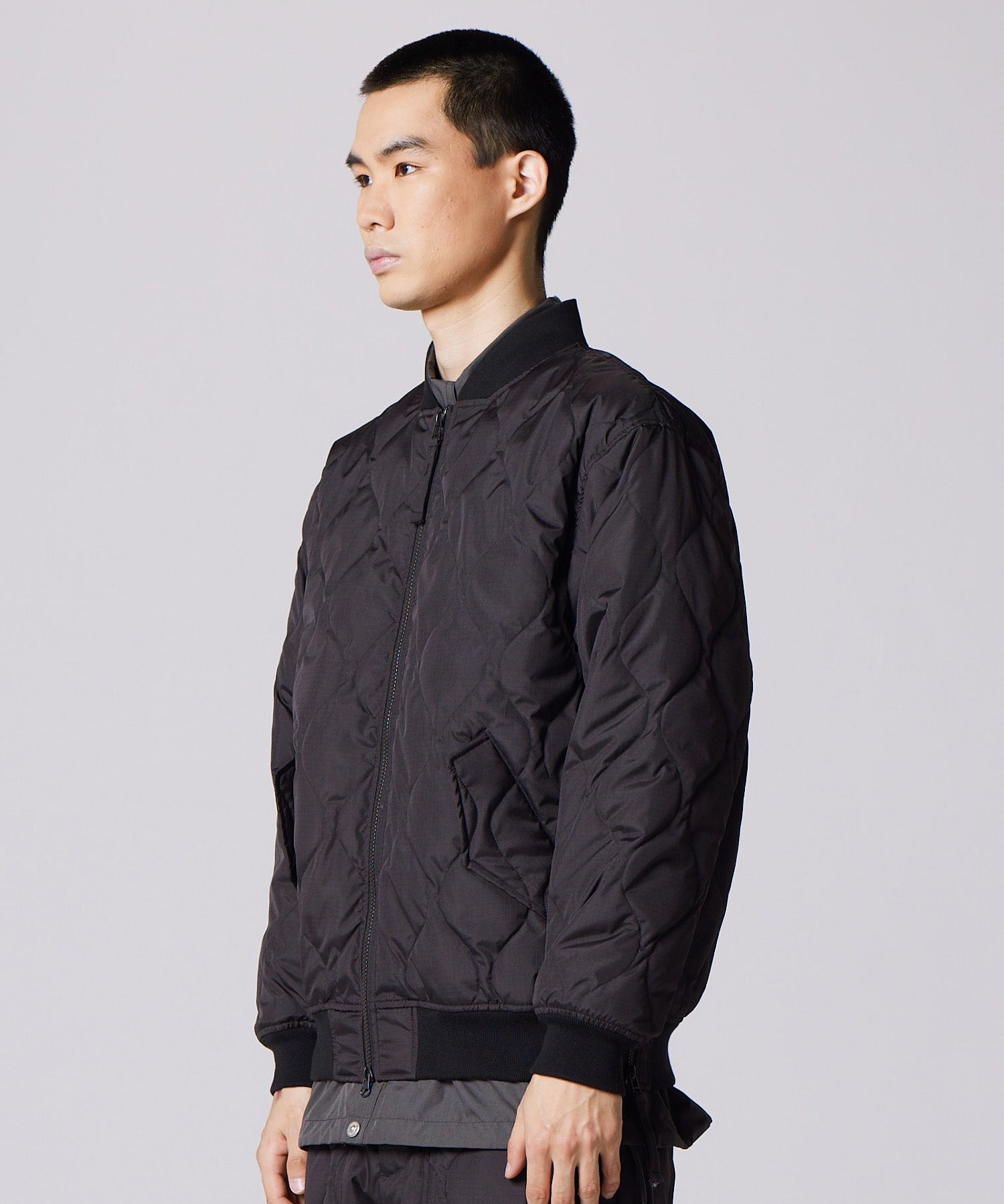 Model wearing Taion Military MA-1 Type Down Jacket in Black with insulated bomber-style fit for everyday wear